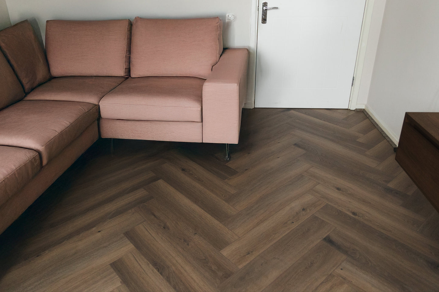 Wooden floor with herringbone pattern in brown tones