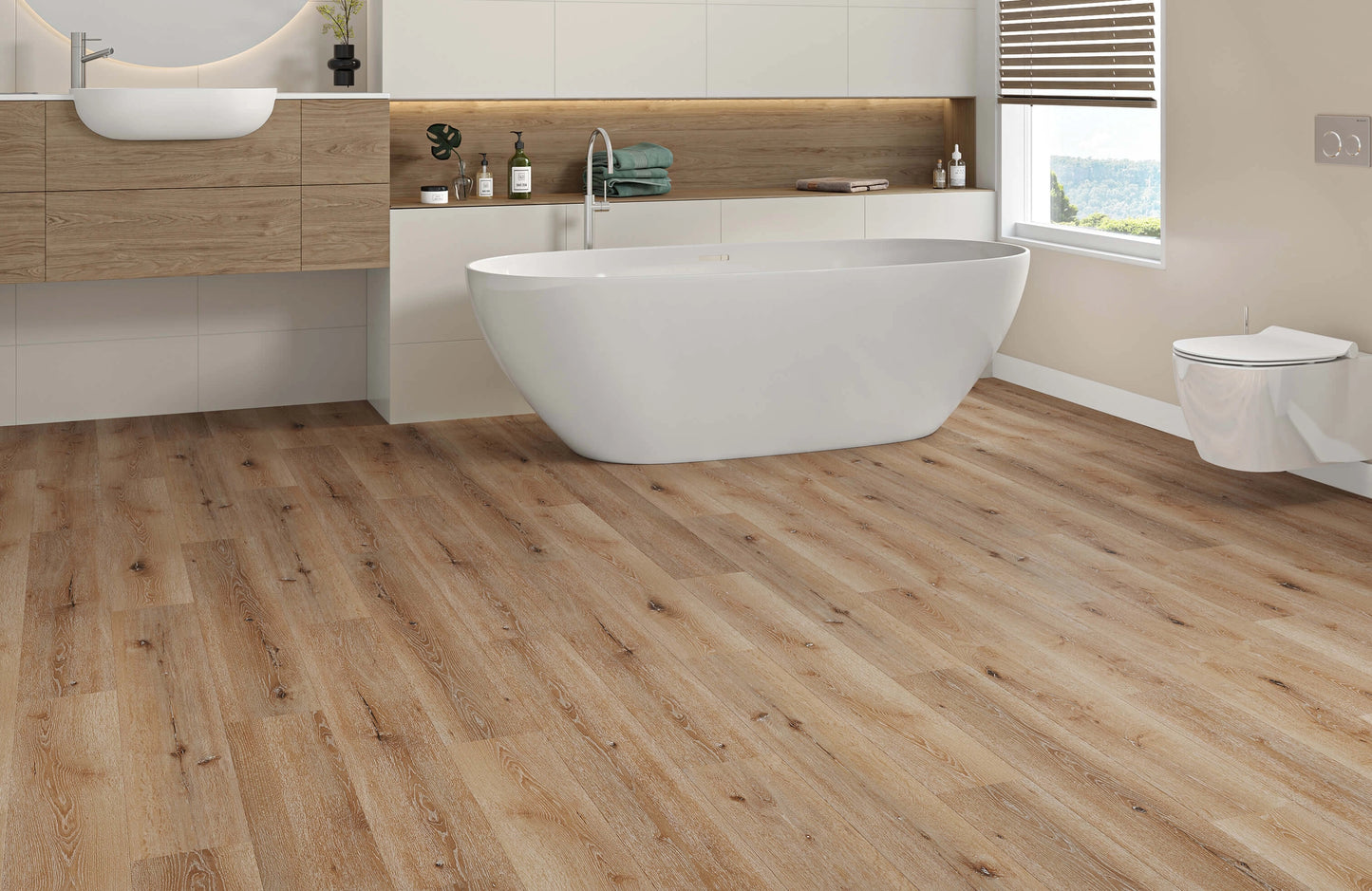 Bathroom with wooden flooring, white freestanding bathtub, and a view of the sea.