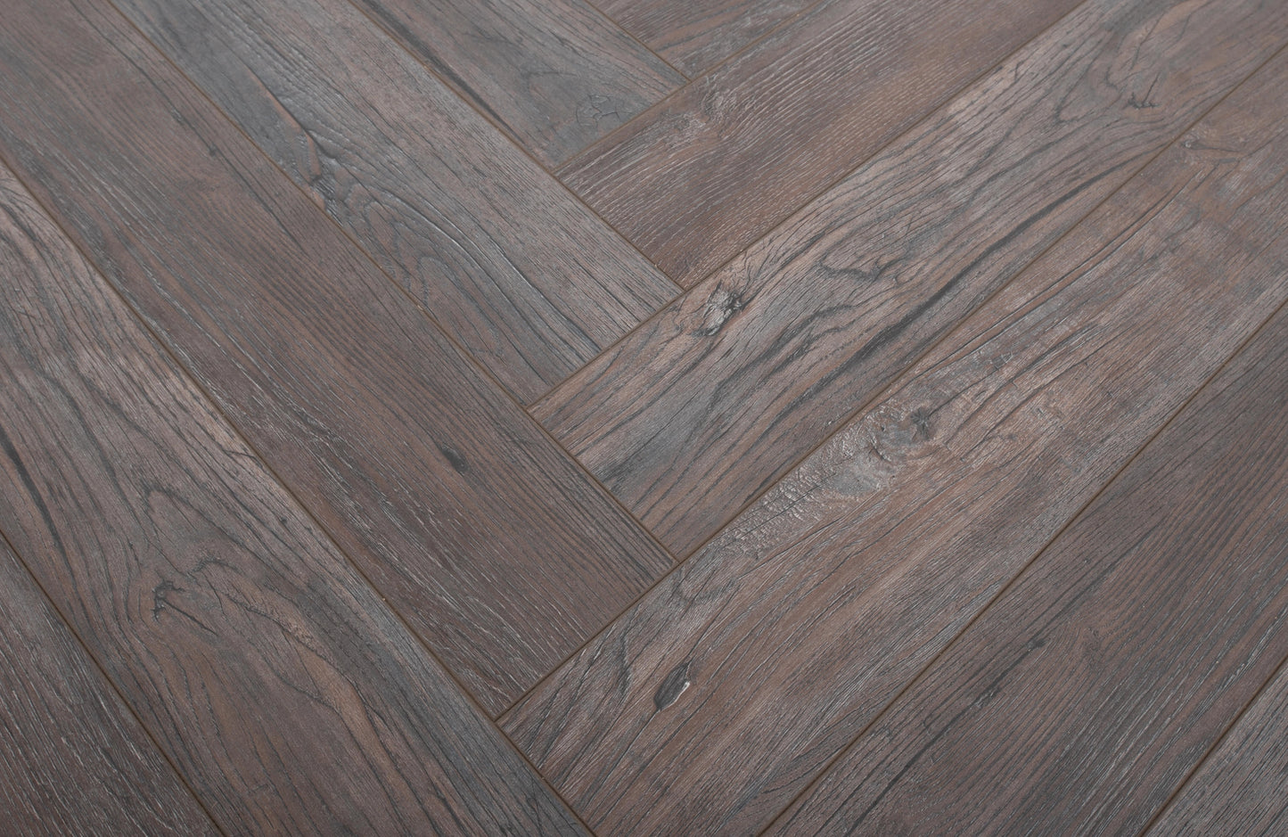 Close-up of a wooden floor with a herringbone pattern