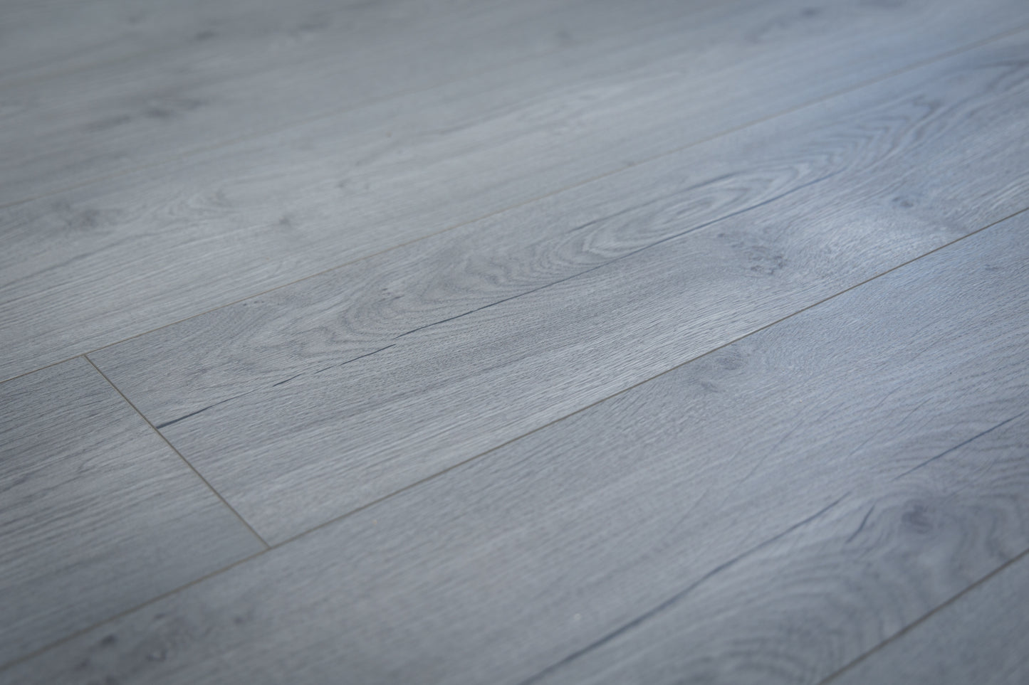 Close-up of gray wooden flooring with a focus on texture and pattern.